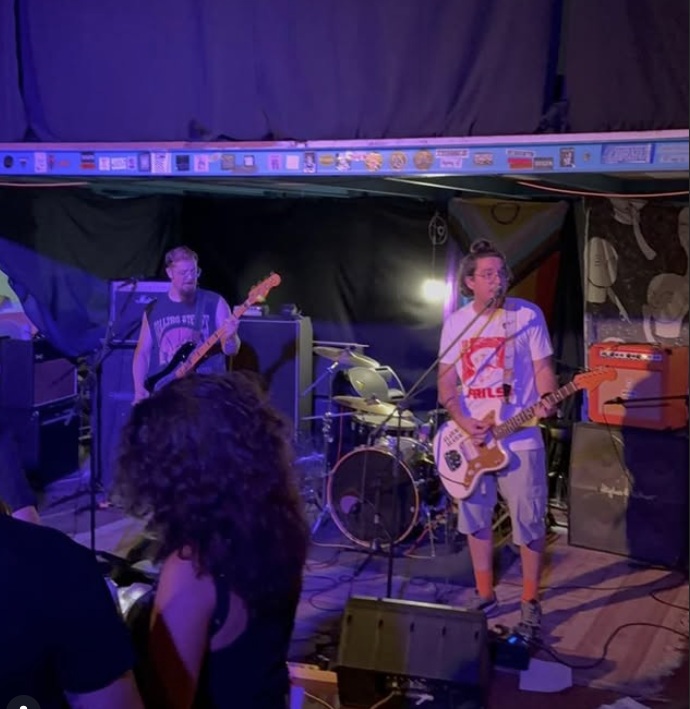 High-energy black and white photo of a crowded mosh pit at a live show