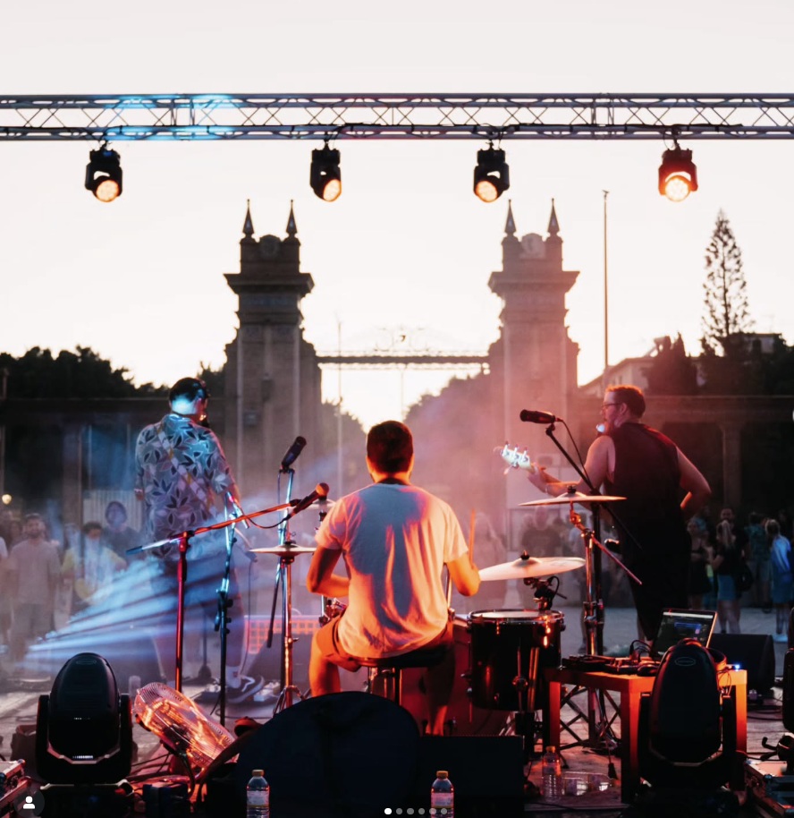 The band performing live on stage in Malaga with stage lighting